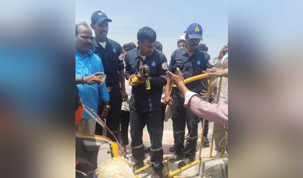 HYDRAA DRF team members attending to an injured auto driver impaled by an iron rod, with rescue equipment visible.