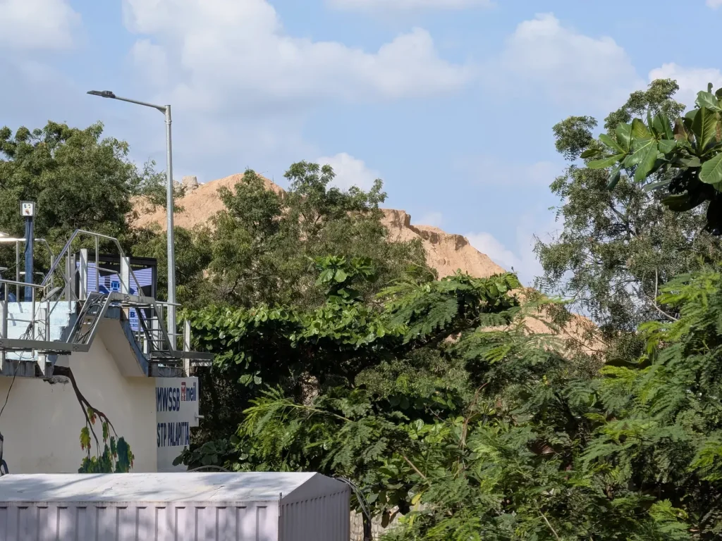A graphic showing a water tap with a drop icon, overlaid with a map of Hyderabad, symbolizing water supply information.