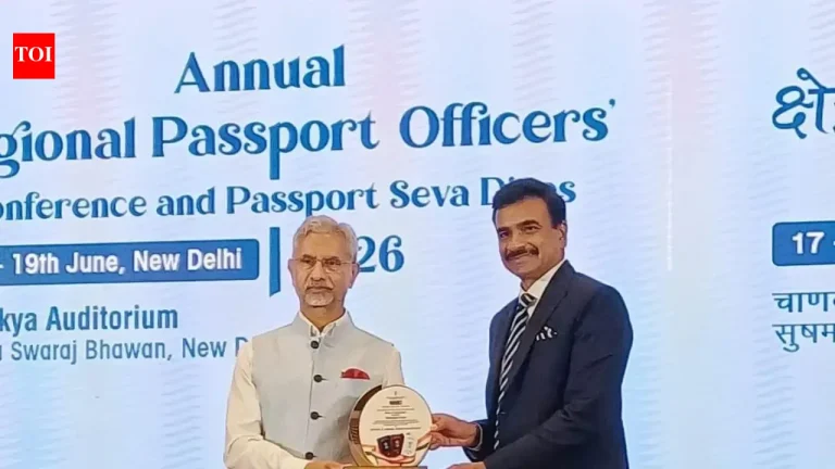 Telangana police official receiving an award for passport services from a Ministry of External Affairs representative