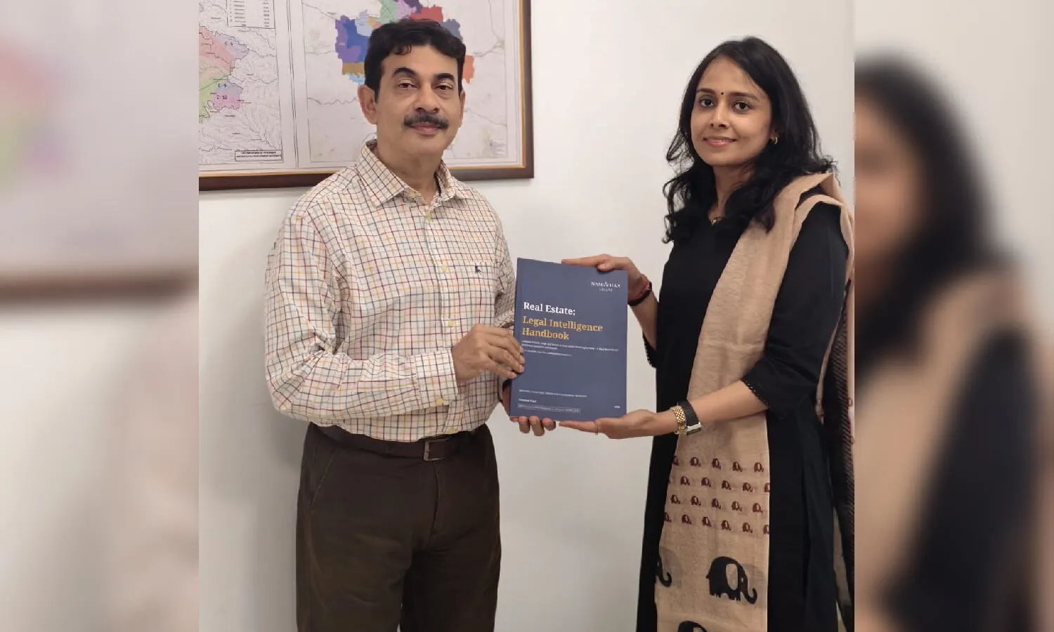 Image of a handbook titled "Indian Real Estate Risk Handbook" with a house icon and legal symbols, representing guidance for property buyers in Hyderabad.
