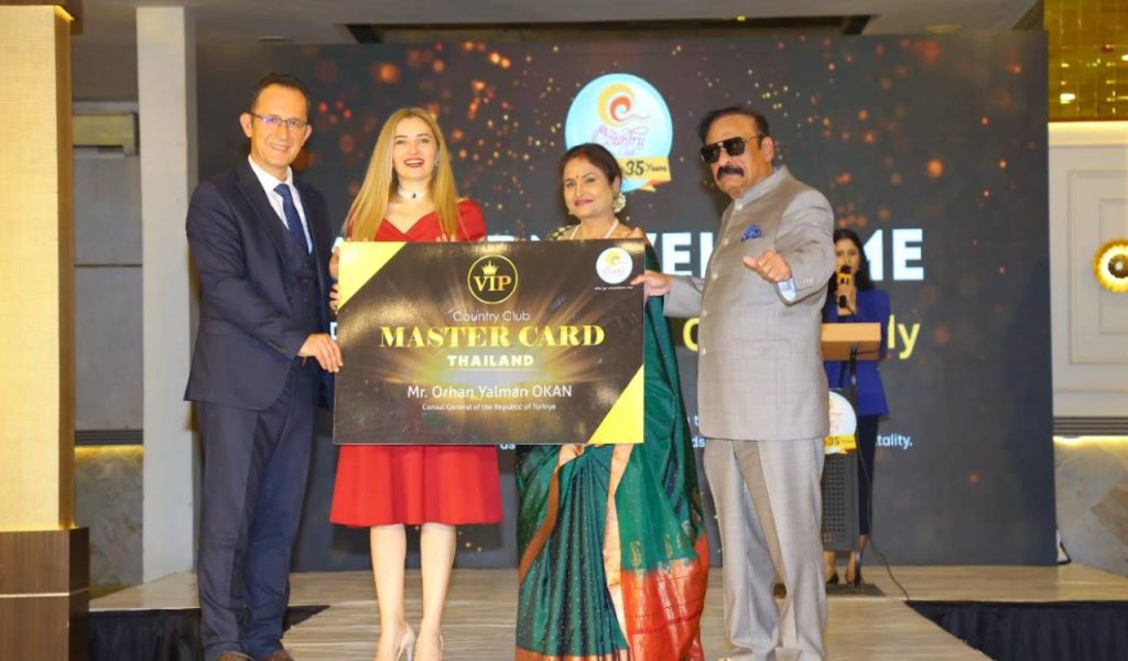 Orhan Yalman Okan, Consul General of Türkiye in Hyderabad, receiving a membership card at the Country Club event.