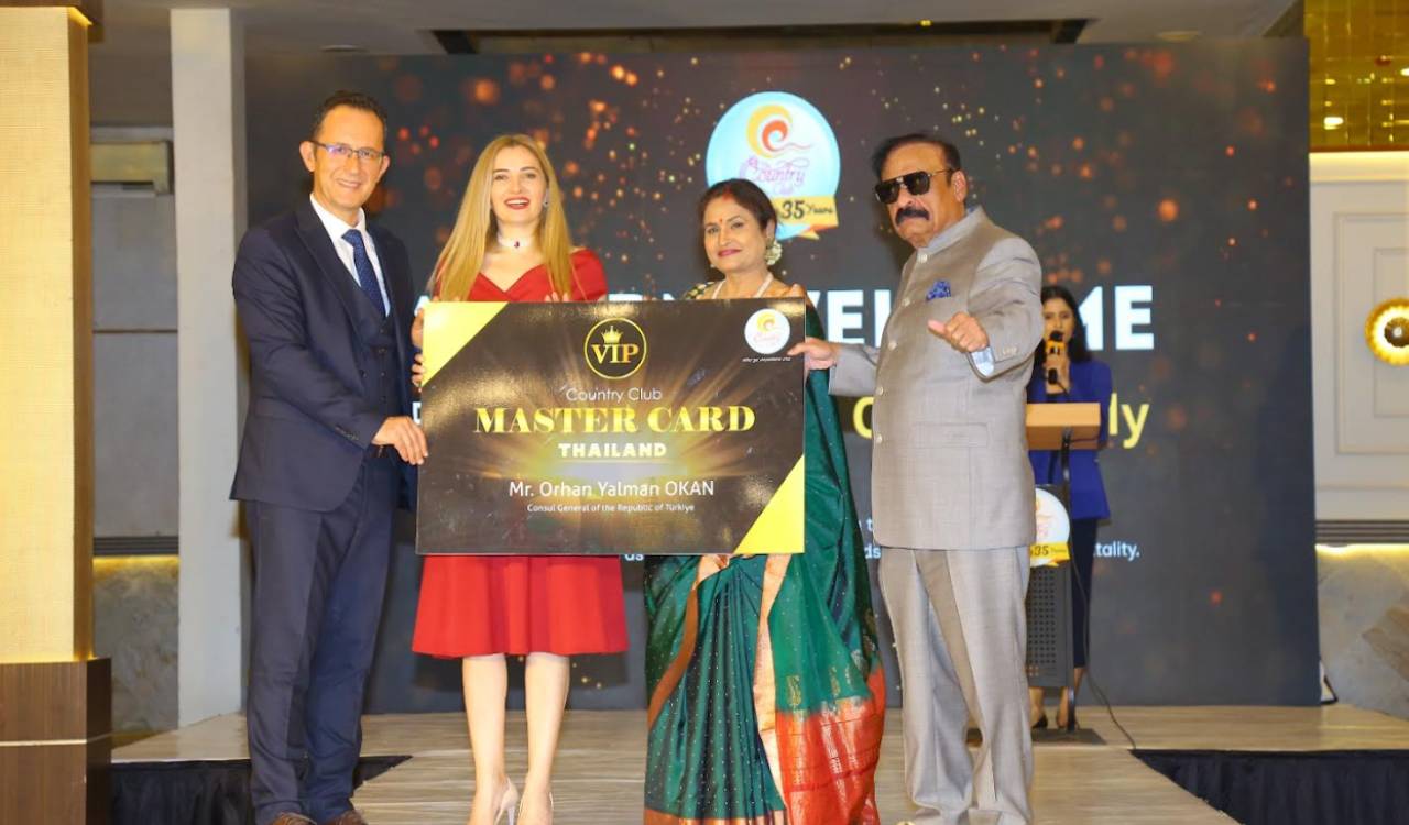 Orhan Yalman Okan, Consul General of Türkiye in Hyderabad, receiving a membership card at the Country Club event.