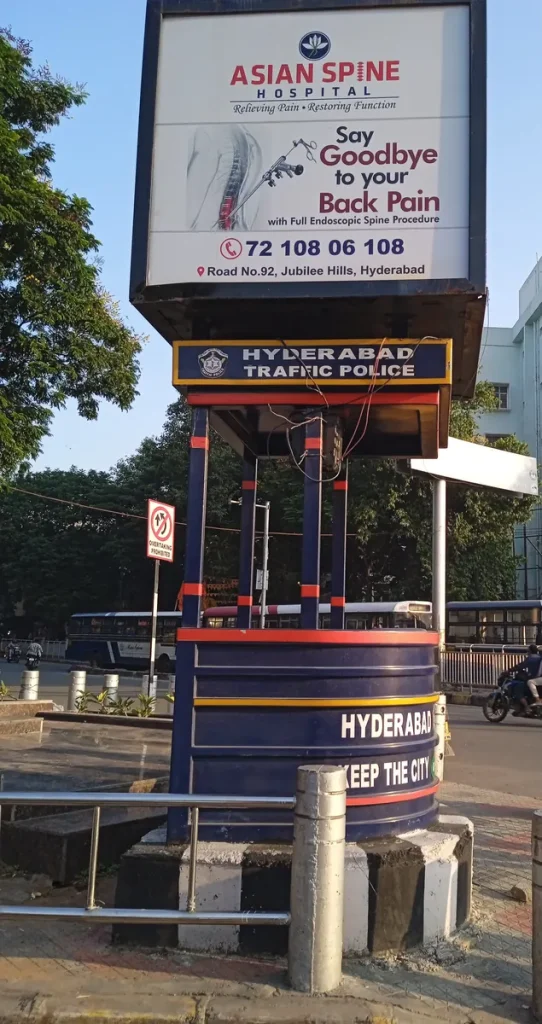 Hyderabad Traffic Police officer directing traffic at a busy intersection.