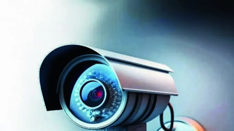 Exterior view of a medical college building with visible security cameras mounted on the walls