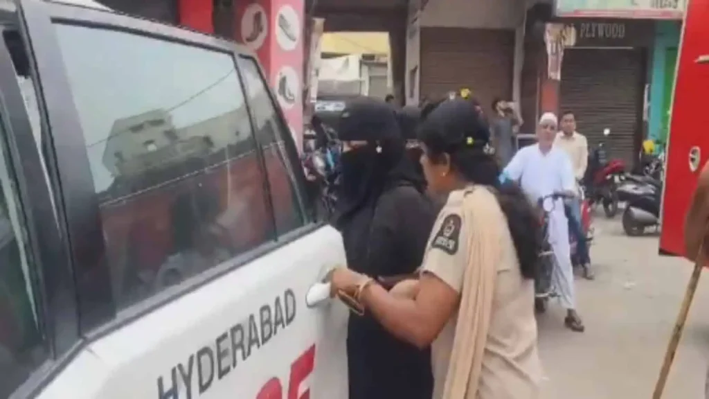 Police constable Rajitha helps a pregnant woman board a patrol vehicle on Shahali Banda X Roads during Ganesh immersion in Hyderabad