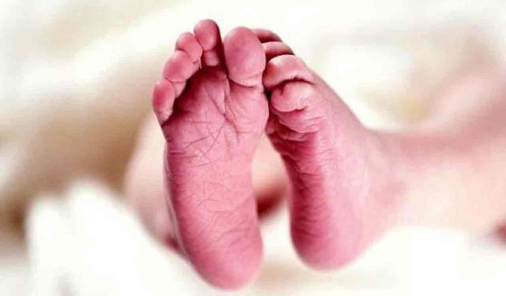 Police and medical staff attending to a newborn baby found abandoned on a roadside in Balanagar, Hyderabad